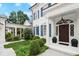 Elegant entryway with a detailed front door, columns, and manicured landscaping at 6440 Westchester Pl, Cumming, GA 30040
