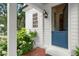 Charming entrance featuring a blue dutch door, white siding, and flowering bushes enhancing curb appeal at 6440 Westchester Pl, Cumming, GA 30040