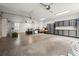 Well-lit and spacious garage with ample storage cabinets and room for multiple vehicles and projects at 6440 Westchester Pl, Cumming, GA 30040