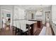 Open kitchen featuring double islands with marble countertops and stainless appliances at 6440 Westchester Pl, Cumming, GA 30040