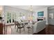 Sunlit living room with fireplace, French doors, and built-in cabinets at 6440 Westchester Pl, Cumming, GA 30040