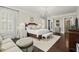 Spacious main bedroom with a chandelier, hardwood floors, and a sitting area at 6440 Westchester Pl, Cumming, GA 30040