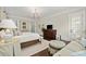 Cozy main bedroom with a sitting area, chandelier, and ample natural light at 6440 Westchester Pl, Cumming, GA 30040