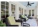Relaxing covered patio featuring wicker furniture, ceiling fan, and double French doors at 6440 Westchester Pl, Cumming, GA 30040