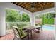 Covered patio with outdoor furniture, a ceiling fan and brick floor overlooking a swimming pool at 6440 Westchester Pl, Cumming, GA 30040