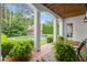 Relax on the brick patio with decorative columns and a view of the pool and landscaped backyard at 6440 Westchester Pl, Cumming, GA 30040