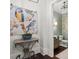 Chic powder room showcasing unique wallpaper, a pedestal sink, and stylish decor at 6440 Westchester Pl, Cumming, GA 30040