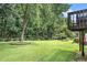 Expansive backyard with lush lawn and mature trees provides privacy at 8605 Stone Creek Ct, Douglasville, GA 30135