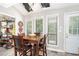 Dining room features a vaulted ceiling with sky lights and a wood table at 8605 Stone Creek Ct, Douglasville, GA 30135