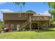Exterior view of home highlighting deck, backyard, and well-maintained lawn at 8605 Stone Creek Ct, Douglasville, GA 30135