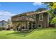 Back exterior features upper level deck and spacious, grassy backyard at 8605 Stone Creek Ct, Douglasville, GA 30135