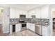 Modern kitchen with stainless steel appliances, granite countertops, and white cabinetry at 8605 Stone Creek Ct, Douglasville, GA 30135