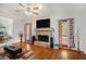 Bright living room with hardwood floors and a stone fireplace at 8605 Stone Creek Ct, Douglasville, GA 30135