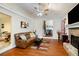Cozy living room with hardwood floors, stone fireplace, and large windows at 8605 Stone Creek Ct, Douglasville, GA 30135