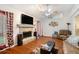 Comfortable living room featuring a stone fireplace and lots of natural light at 8605 Stone Creek Ct, Douglasville, GA 30135
