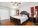 Spacious main bedroom featuring a ceiling fan and large window for natural light at 8605 Stone Creek Ct, Douglasville, GA 30135
