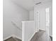 Hallway with gray wood floors leading to a light-filled room at 1510 Paramount Ln, Sugar Hill, GA 30518