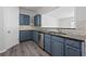 Well-equipped kitchen featuring blue cabinets, stainless steel appliances, and modern countertops at 1510 Paramount Ln, Sugar Hill, GA 30518