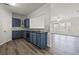 Modern kitchen featuring blue cabinets, stainless steel appliances, granite countertops and hardwood floors at 1510 Paramount Ln, Sugar Hill, GA 30518