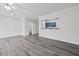 Open-concept living room featuring light gray flooring, a ceiling fan and a view into the kitchen at 1510 Paramount Ln, Sugar Hill, GA 30518