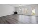 Spacious living room featuring hardwood floors, fireplace, and plenty of natural light at 1510 Paramount Ln, Sugar Hill, GA 30518