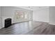 Bright living room with hardwood floors, a fireplace, and large windows offering lots of natural light at 1510 Paramount Ln, Sugar Hill, GA 30518