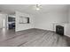 Bright living room showcasing a fireplace, light gray floors, and an open view to the kitchen at 1510 Paramount Ln, Sugar Hill, GA 30518