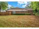 A fenced backyard features a brick home with a manicured lawn and trimmed hedges at 3221 Abbott Dr # 5, Powder Springs, GA 30127
