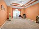 Spacious carpeted bedroom with a tray ceiling, fan and window with sheer curtains at 3221 Abbott Dr # 5, Powder Springs, GA 30127