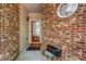 Close-up of entryway with red door and brick exterior with round window at 3221 Abbott Dr # 5, Powder Springs, GA 30127