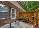 A cozy patio features a small table and chairs, plants and access to the home at 3221 Abbott Dr # 5, Powder Springs, GA 30127