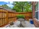 Private patio area enclosed by a wooden fence, perfect for outdoor relaxation and entertaining at 3221 Abbott Dr # 5, Powder Springs, GA 30127