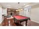 Finished basement with a pool table, hardwood floors, and a seating area at 412 Mill Stream Way, Woodstock, GA 30188