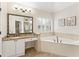 Spa-like bathroom with a soaking tub, granite countertops, and a separate shower at 412 Mill Stream Way, Woodstock, GA 30188