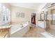 Elegant bathroom with a soaking tub, walk-in shower, and marble countertops at 412 Mill Stream Way, Woodstock, GA 30188
