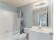 Bright bathroom with a shower-tub combo, vanity sink, and blue accents at 412 Mill Stream Way, Woodstock, GA 30188