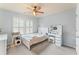 Light and airy bedroom featuring neutral decor, a ceiling fan, and bright natural light at 412 Mill Stream Way, Woodstock, GA 30188