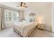 Charming bedroom with a ceiling fan, bright windows, and stylish decor at 412 Mill Stream Way, Woodstock, GA 30188
