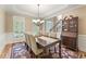 Elegant dining room with hardwood floors, wainscoting, and a chandelier at 412 Mill Stream Way, Woodstock, GA 30188