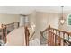 Open hallway featuring decorative railings, a carpeted floor, and natural light at 412 Mill Stream Way, Woodstock, GA 30188