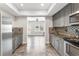 Modern kitchen with gray cabinetry, stainless steel appliances, and updated backsplash at 412 Mill Stream Way, Woodstock, GA 30188