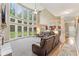 Bright living room featuring a stone fireplace, plush carpeting, and a wall of windows overlooking the backyard at 412 Mill Stream Way, Woodstock, GA 30188