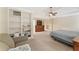 Large main bedroom complete with a seating area, built in bookcase, and tray ceiling at 412 Mill Stream Way, Woodstock, GA 30188
