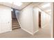 Finished basement area with carpeted stairs, neutral walls, and multiple entryways at 5602 Asheforde Ln, Marietta, GA 30068