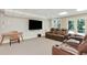 Finished basement with a media center and leather seating at 5602 Asheforde Ln, Marietta, GA 30068