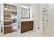 Beautiful bathroom featuring a dark wood vanity, walk-in closet, and access to the main bedroom at 5602 Asheforde Ln, Marietta, GA 30068