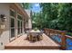 Exterior deck with dining table and seating overlooking a private backyard at 5602 Asheforde Ln, Marietta, GA 30068