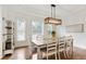 Dining room featuring a modern chandelier, neutral walls, and bright windows at 5602 Asheforde Ln, Marietta, GA 30068