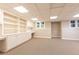 Finished basement flex room with built in shelving and modern carpet at 5602 Asheforde Ln, Marietta, GA 30068