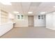 Finished basement flex room with built in shelving and modern carpet at 5602 Asheforde Ln, Marietta, GA 30068